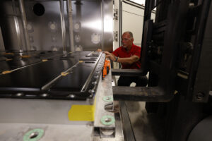 A UL Solutions engineers prepare to test an EV battery in the an environmental test chamber